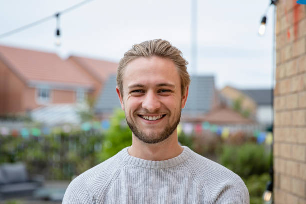 Man standing outdoors looking at the camera while at a social gathering for a birthday bbq in the North East of England.